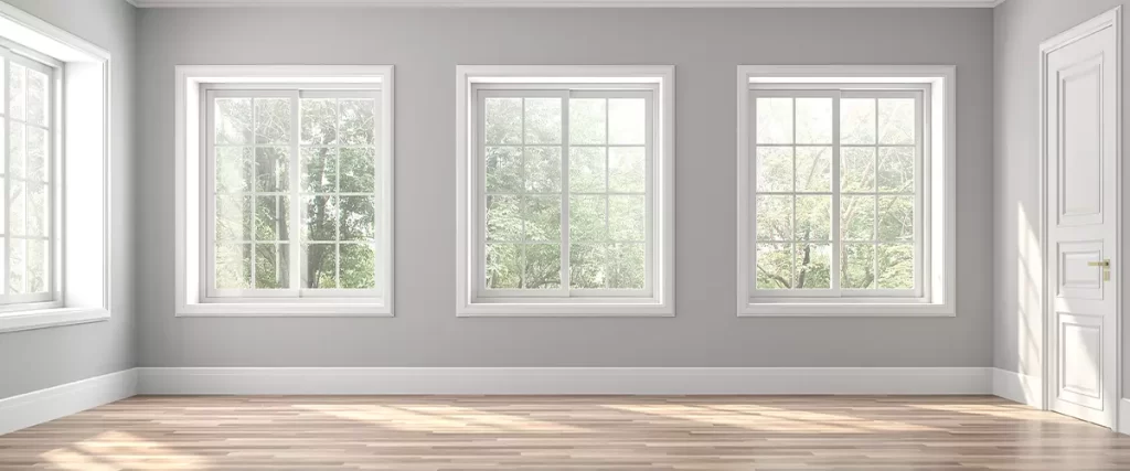 Classical empty room interior with wooden floors and gray walls ,decorate with white moulding,there are white window looking out to the nature view