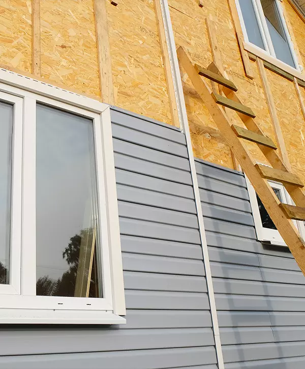 siding installation covering the wall of a house under construction